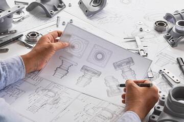 Engineer technician designing drawings mechanical parts engineering Engine.manufacturing factory...