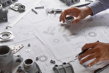 Engineer technician designing drawings mechanical parts engineering Engine.manufacturing factory...