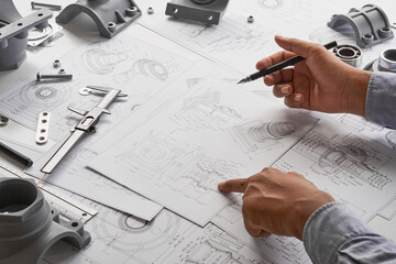 Engineer technician designing drawings mechanical parts engineering Engine.manufacturing factory...