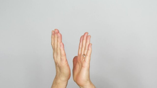 A pair of hands making clapping and patting rhythmically.
