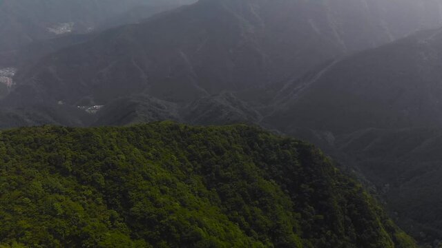 Stunning Green Forest And  Mountain Ridges In Distance - Aerial Shot Tilt-Up
