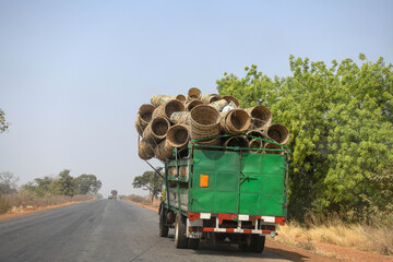 A truck fully loaded with sorrel baskets on a road in northern Benin.