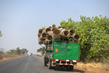 A truck fully loaded with sorrel baskets on a road in northern Benin.