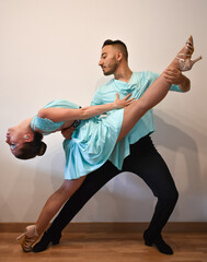 Salsa and bachata dancers doing a dance pose