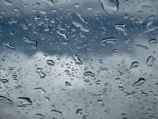 Raindrops on the window, rainy day. Storm clouds