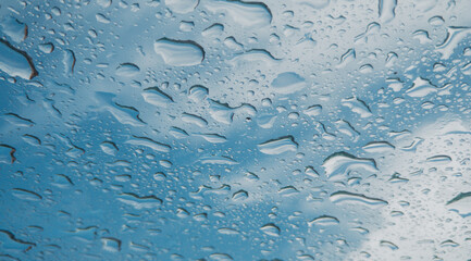 Raindrops on the window, rainy day. Storm clouds