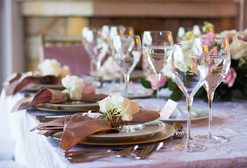 glasses of wine and plates in an elegant and formal banquet of a weddi