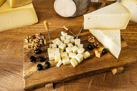 Composition of cheese cubes on a wooden table