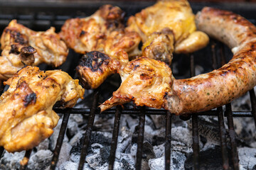 chicken and beef sausage, pork on a barbecue
