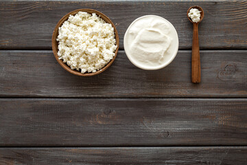 Cottage cheese in bowl with spoon - for breakfast - top view copy space
