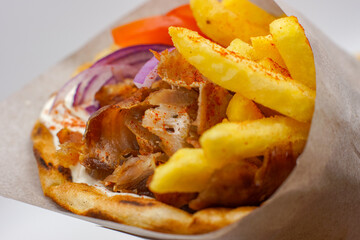 Lamb / Pork Gyros With Chips Bread Wrap Salad Tomatoes Seasoning Fries Wrapped Up Presented Wooden Greek Food Fast 