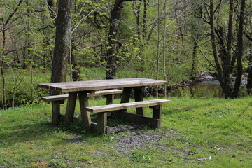 A picnic table beside the river Dulas in Wales, UK. 