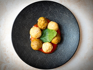 Vegan legume meatballs with fresh tomato sauce and basil leafe