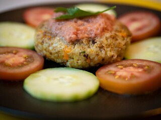 Vegan legume burger with fresh tomato and cucumber slices