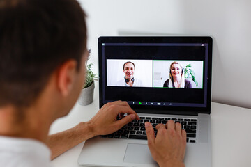 Young woman smiling while videoconferencing at home during coronavirus self quarantine. Family video conversation via internet, couple on distance, home isolation lockdown closed boarders.