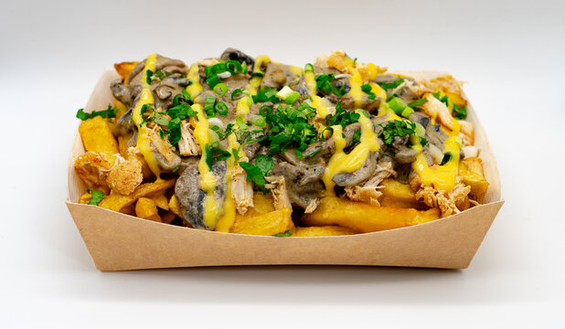 Isolated Skin On Poutine Fries Topped With Chicken, Mushrooms and Cheese In Cardboard Box