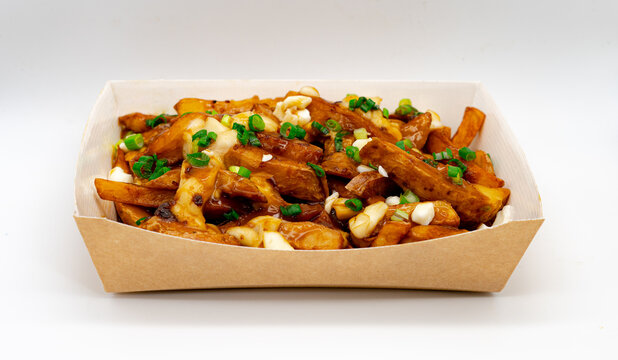 Isolated Original Canadian Poutine,  Skin On Fries Topped With Gravy And Cheese Curds In Cardboard Box