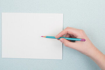 pencil in hand on a blue and white background