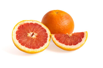 Ripe red whole and sliced grapefruit on white background. Minimal fruit concept.