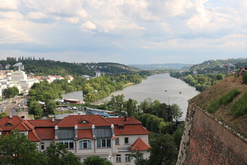 Fototapeta na wymiar Panorama of Prague and the Vltava river on a hot, cloudy summer day