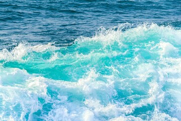 Fototapeta na wymiar Blue wave in tropical ocean. Turquoise wave barrel crashing in sea. Close up.