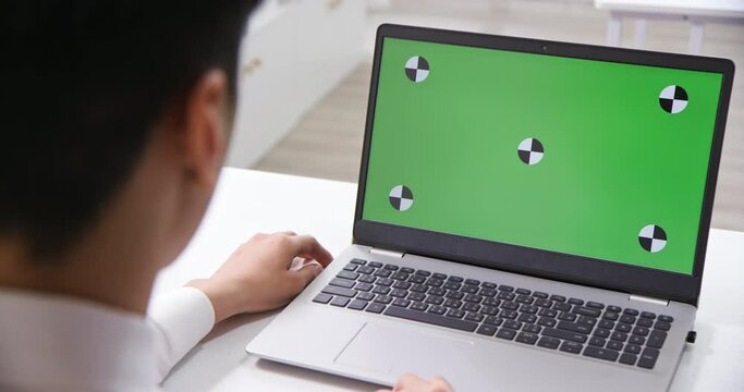 man look green screen laptop