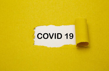 Torn brown paper with Covid 19 text on white background