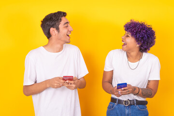 smiling young couple with mobile phones isolated on background