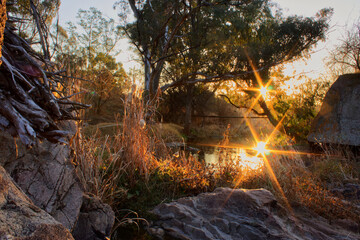 Double sunset The reflection of the sun on the jukskie River creates the effect of two suns. I had to wait for the perfect time for the sun to get into position