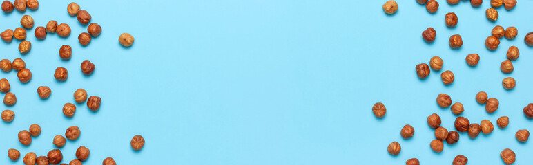 Creative food layout. Hazelnuts on blue background top view copy space. Concept of food, healthy nutrition, nut, healthy fats. Hazelnut Flat lay. Walnut pattern. Organic healthy vegan snack