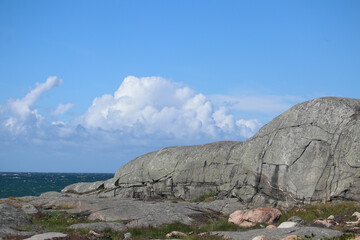 Rolling granite hill on Swedish coast with ocean background