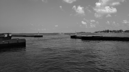 Black and white picture of boats at the harbor next to Ibrahim Nasir International Airport in Male, Maldives. Summer Holidays in Southeast Asia. 