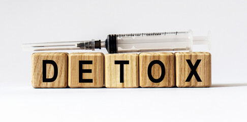 Text DETOX made from wooden cubes. White background
