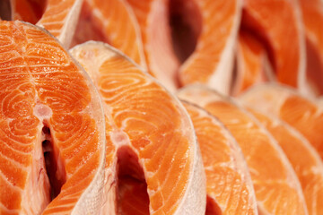 Fresh pink salmon steaks in the ice. Red fish in the market, concept of healthy food with omega fats, fishing industry