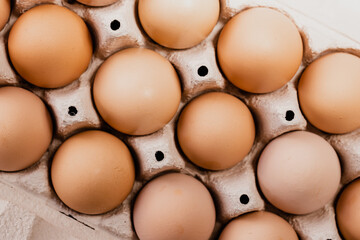 Fresh chicken eggs in carton egg tray or wood boxes
