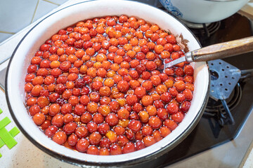 Homemade cherry jam. Cooking sweet merry jam. Side view