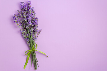 Lavender flowers bouquet on violet background, rustic still life with free space for text