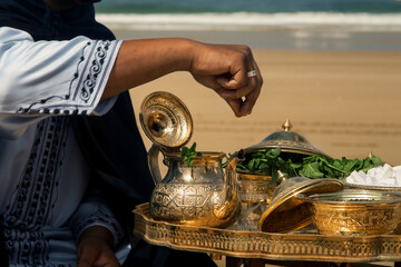 wedding ceremony on the ocean in Morocco, traditional Moroccan tea with mint