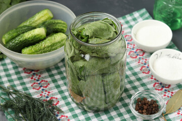 Marinated cucumbers in grape leaves in jars for the winter with garlic and dill, preparatory process