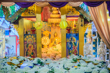 People praying with jasmine flower at Wat Phra That Doi Kham (often referred to as Wat Doi Kham or the Golden temple) is located at the top of a hill to the south west of the city.