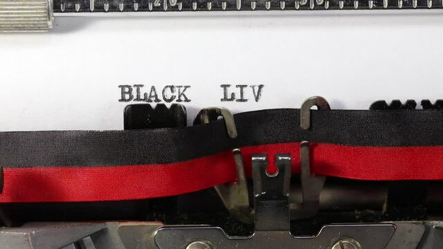 writing on the vintage typewriter the text BLACK LIVES MATTER  on the paper