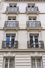 View of Unique traditional French windows and balconies. Paris, France.