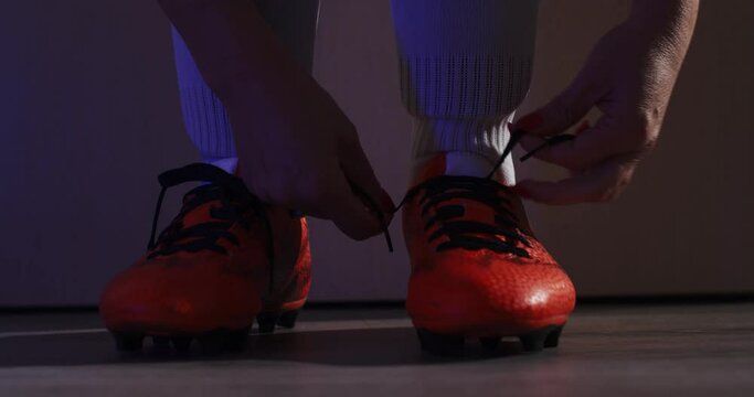 Female soccer football. Professional soccer football woman player put on her shoes. 4k Slow Motion