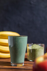 promotional shooting of a fruit cocktail for a healthy eating establishment. In the photo, a glass with a green drink made from fruits and algae spirulina powder
