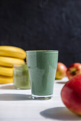 Smoothie with fresh red apple, banana and spirulina powder. Summer vitamin refreshing drink. Healthy detox diet