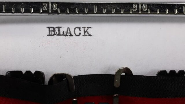 writing on the vintage typewriter the text BLACK LIVES MATTER  on the paper