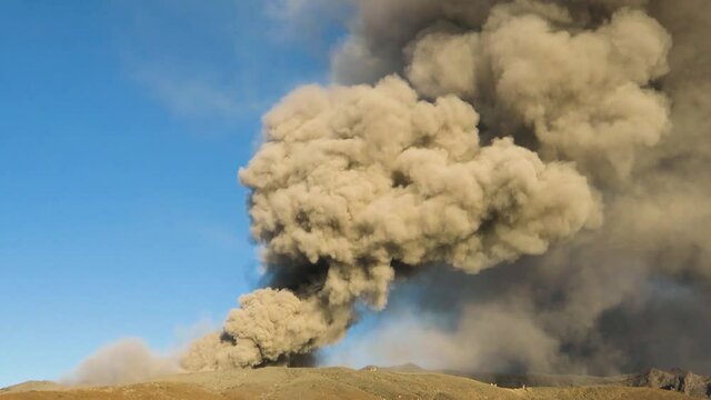 Mount Aso volcano during eruption, releasing ash and steam, close view. Aso-Kuju National Park on Kyushu Island, Japan. 