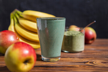 promotional shooting of a fruit cocktail for a healthy eating establishment. In the photo, a glass with a green drink made from fruits and algae spirulina powder