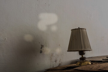 old lamp and a white wall in a room