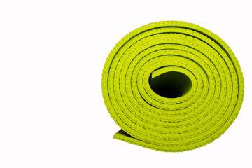 Fototapeta na wymiar The yoga mat is twisted into a roll of green color isolated on a white background with place for your text.